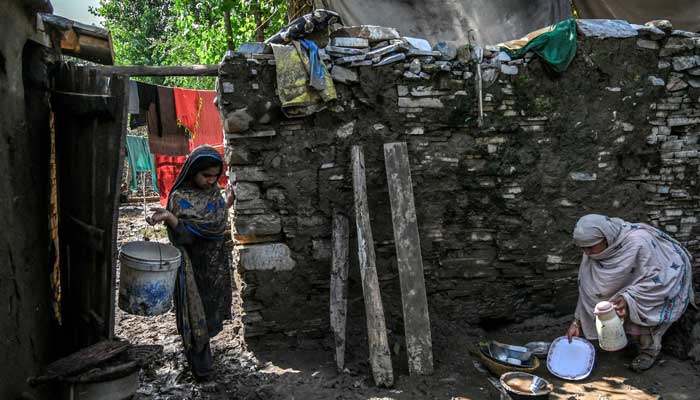Residents remove debris and mud from their homes, after flash floods hit Buner district in Khyber Pakhtunkhwa on August 18, 2025. — AFP