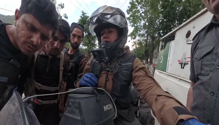 Police personnel interect with Holland’s renowned motorcyclist and vlogger, Noraly (second from right). — screengrab/Itchy Boots/File
