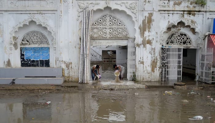 Men remove water from a mosque following heavy rain in Karachi, Pakistan, August 20, 2025.—Reuters