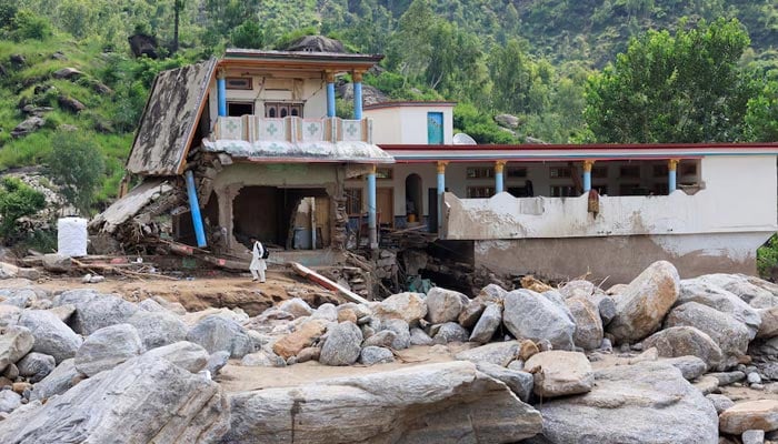 A view of the damaged family house of Noor Muhammad, 25, who lost 24 family members and relatives, which was hit by devastating floods in the mountainous Qadir Nagar village of Buner district. — Reuters