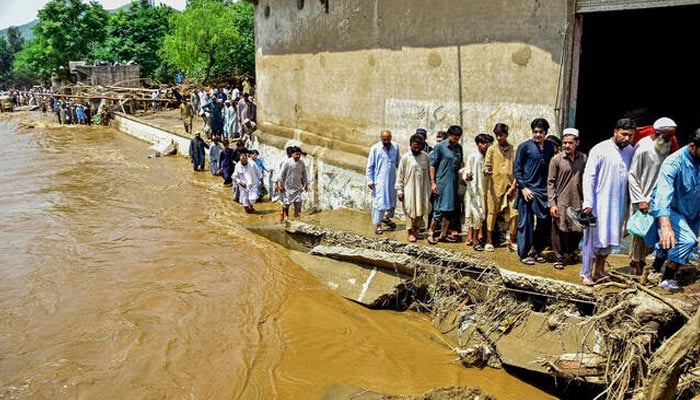 Residents walk alongside a stream a day after flash floods in the Buner district of Khyber Pakhtunkhwa province on August 16, 2025. — Reuters