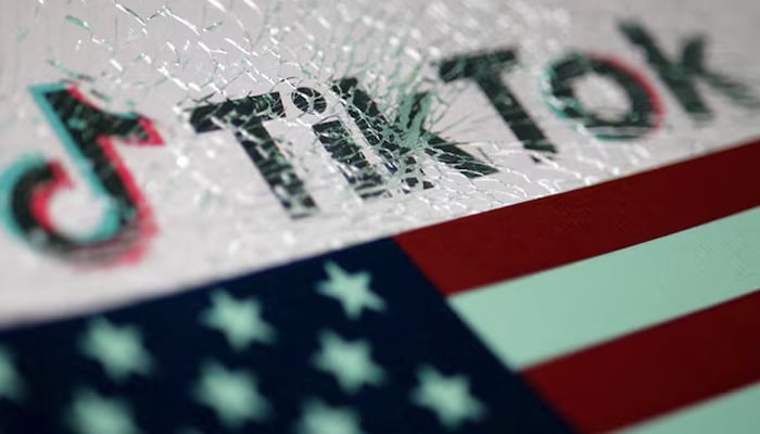 The US flag and the TikTok logo seen through broken glass are seen in this illustration taken January 16, 2025. — Reuters