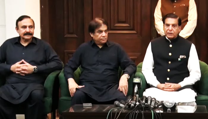 PML-N leader Hanif Abbasi (centre) addresses a press conference flanked by PML-N’s Tariq Fazal Chaudhry (left) and PPP’s Raja Pervaiz Ashraf in Islamabad on August 23. — Geo News
