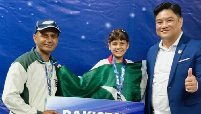Pakistan’s youngest taekwondo champion Ayesha Ayaz receives her medal. — APP