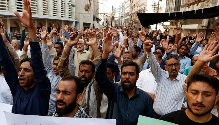 People raise slogans during a protest in Karachi on November 22, 2024. — Reuters