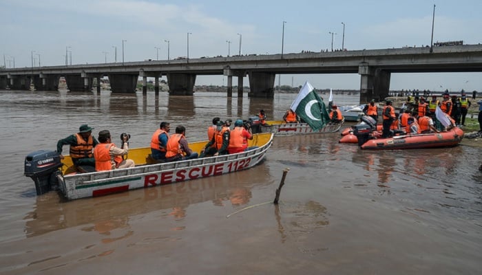 Rescue workers take part in a flood exercise on June 4, 2020, in the Ravi River in Lahore. —AFP/File