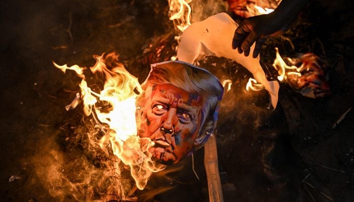 Activists of different trade unions burn an effigy of US President Donald Trump to protest against the recent tariff hikes imposed by the US on India during a demonstration in Kolkata, India, on August 13, 2025. — AFP