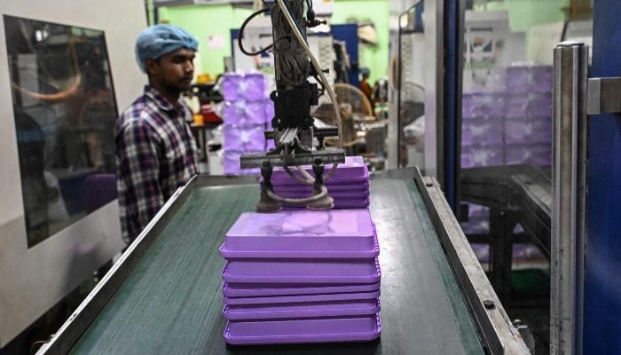 A general view shows the manufacturing of virgin plastic food containers at a factory in Howrah district on the outskirts of Kolkata ,India, on August 8, 2025. — AFP