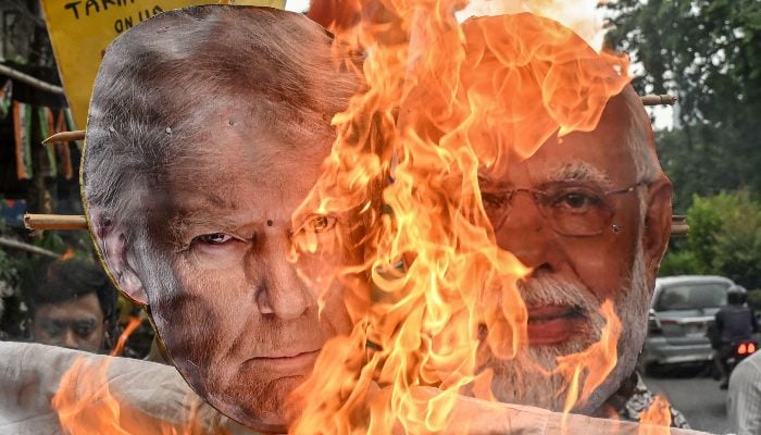 Congress activists burn an effigy of US President Donald Trump and Indian Prime Minister Narendra Modi, during a demonstration in Kolkata on August 1, 2025. — AFP
