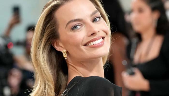 Margot Robbie laughs as son crashes her interview