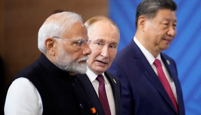 Indian Prime Minister Narendra Modi, Russian President Vladimir Putin and Chinese President Xi Jinping attend a family photo ceremony prior to the BRICS Summit plenary session in Kazan, Russia, Wednesday, Oct. 23, 2024. — Reuters