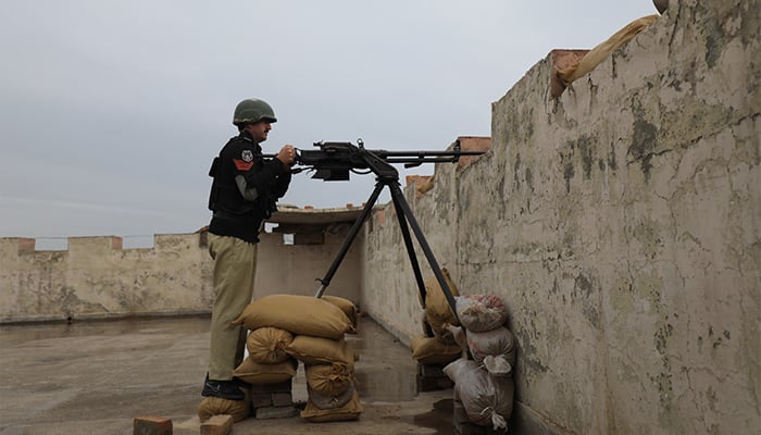 A police officer with a 12.7mm infantry machine gun takes position at Sarband Police Station’s rooftop, in the outskirts of Peshawar, Pakistan, February 9, 2023. — Reuters