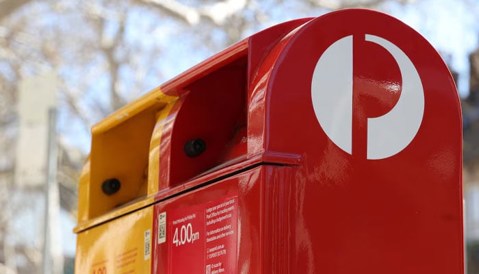 An Australia Post red street posting box stands alongside an express post box in Sydney, Australia, August 26, 2025. — Reuters