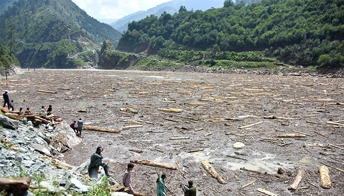 Locals collect woods from the Noseri Dam near Muzaffarabad, capital of Pakistan-administered Kashmir on August 16, 2025. — AFP