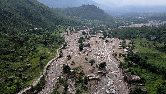 An aerial view shows houses partially submerged in sludge along a riverbed in the aftermath of flash floods at the Buner district of mountainous Khyber Pakhtunkhwa on August 17, 2025. — AFP