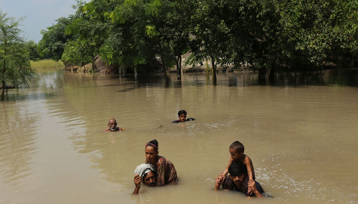 Villages submerged, rescue underway as Punjab reels under deluge 25 Villagers wade through a flooded street following heavy rains at the Ehsan Pur village in Kot Addu district in this image released on August 27, 2025. — AFP