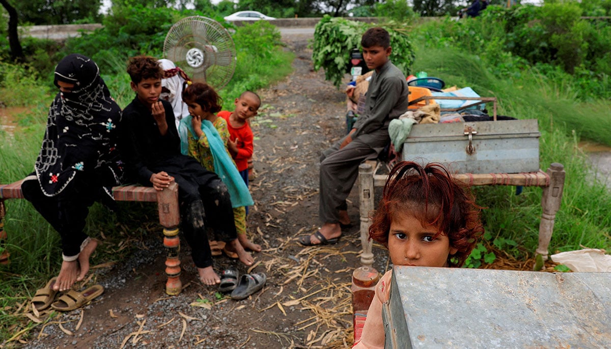 Villages submerged, rescue underway as Punjab reels under deluge 21 A family with their belongings takes refuge along a road near Chenab River, following the monsoon rains and rising water level in Wazirabad, in Punjab on August 27, 2025. — Reuters