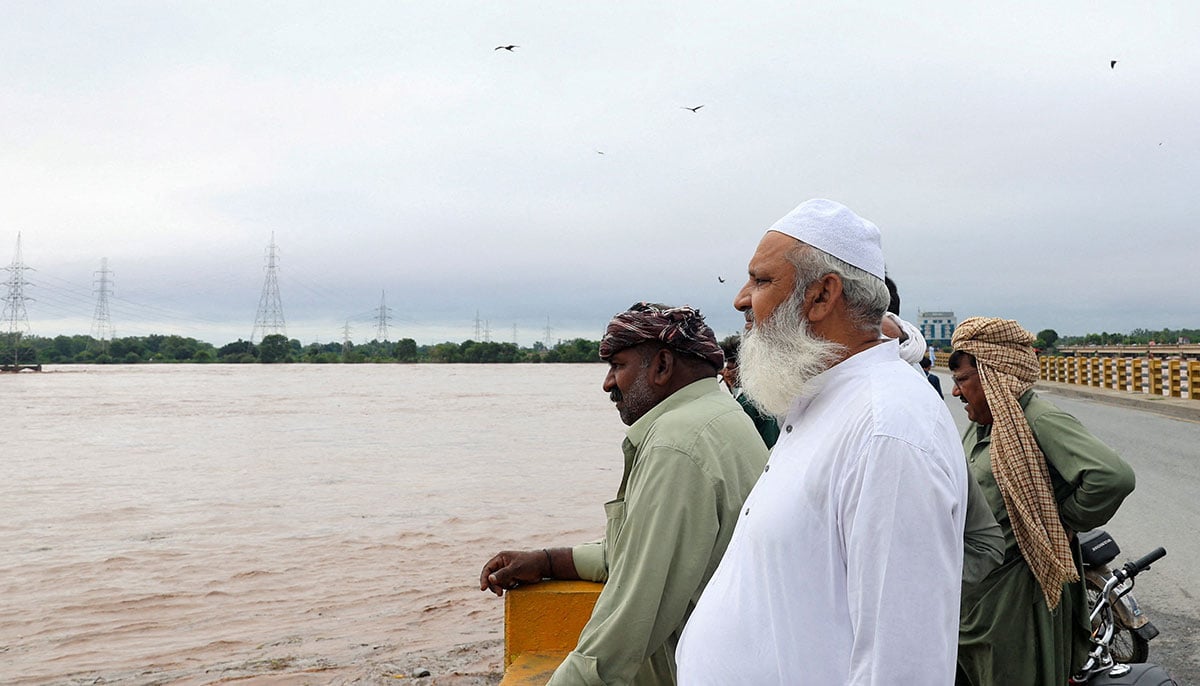 Villages submerged, rescue underway as Punjab reels under deluge 20 People stand on a bridge over the Chenab River, following the monsoon rains and rising water level in Wazirabad, in Punjab on August 27, 2025. — Reuters