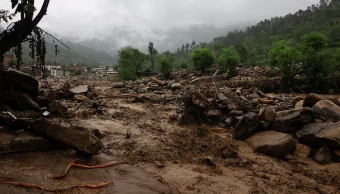 Rain water flowing from mountains crosses a damaged area, following a storm that caused heavy rains and flooding in Bayshonai Kalay, in Buner district, in KP, August 18, 2025. — Reuters