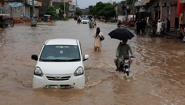 Vehicles move along a flooded street following monsoon rains and rising water levels in Sialkot, August 27, 2025. — Reuters