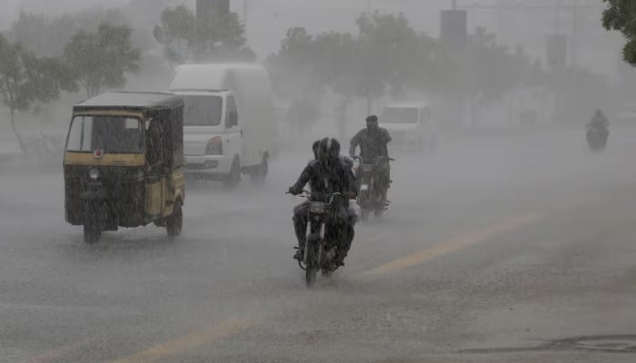 Commuters travel on a road during heavy rain in Karachi, Pakistan, August 20, 2025. —Reuters