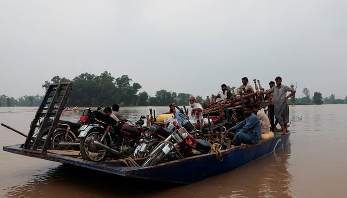 Residents travel with their belongings on a boat as they head towards higher ground, following the monsoon rains and rising water level of the Sutlej River,  August 29, 2025.— Reuters