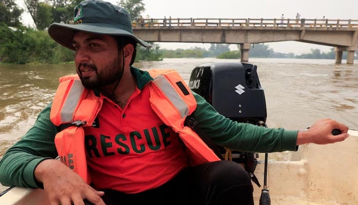 Muhammad Arslan, 27, an operator at Rescue 1122, drives a boat heading to evacuate residents, following the monsoon rains and rising water level of the Sutlej River in Kasur district of the Punjab province, August 29, 2025. — Reuters