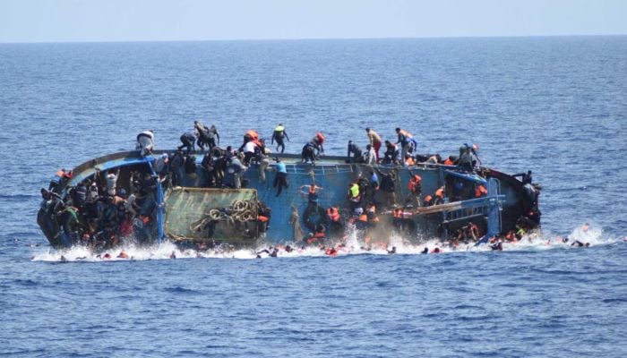 Representational image shows migrants on a capsizing boat off the coast of Libya in this handout picture released by the Italian Marina Militare on May 25, 2016. — Reuters