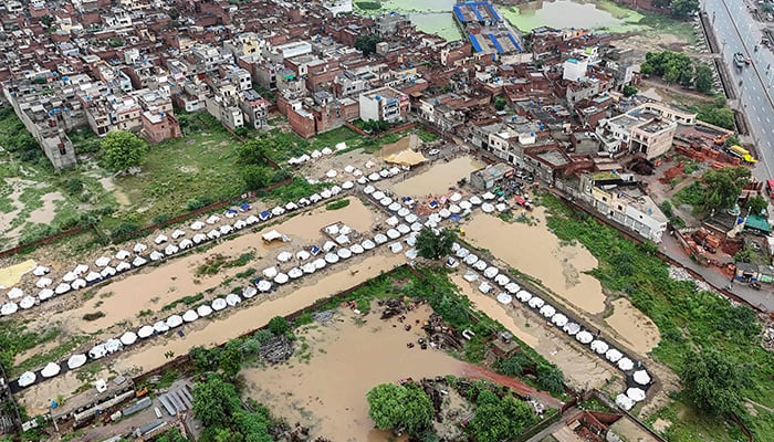 This aerial view shows makeshift shelters built for flood-affected people in Chung, in Punjab province, on August 31, 2025. — AFP