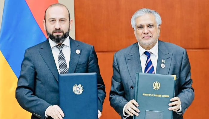Deputy PM and Foreign Minister Senator Ishaq Dar (right) and Armenian FM Ararat Mirzoyan sign and exchange a joint communique establishing diplomatic relations between Pakistan and Armenia. — X@MIshaqDar50