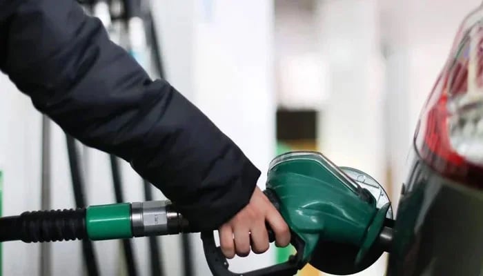 A person fills their cars tank at a fuel station in this undated image. — AFP/File