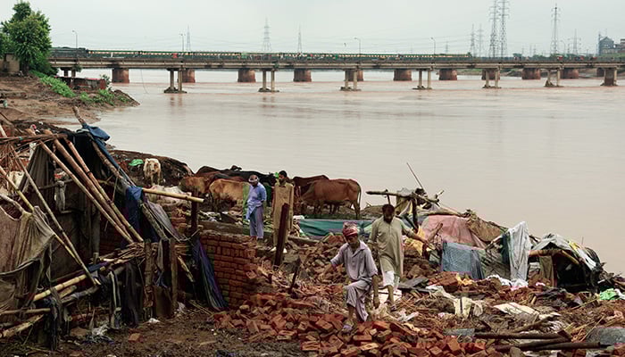 Residents inspect the remains of damaged property after water levels receded along the right bank of the Ravi River, following recent floods caused by monsoon rains, in Lahore, Pakistan August 31, 2025. — Reuters