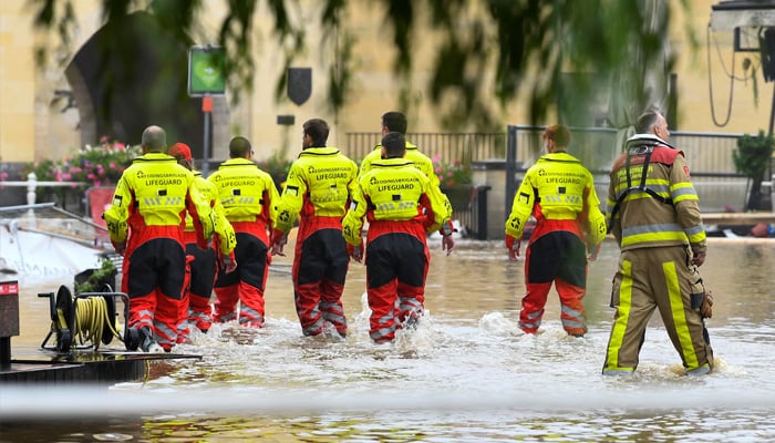 Lifeguards walk through a flooded street, following heavy rainfalls, in Valkenburg, Netherlands, July 15, 2021. — Reuters