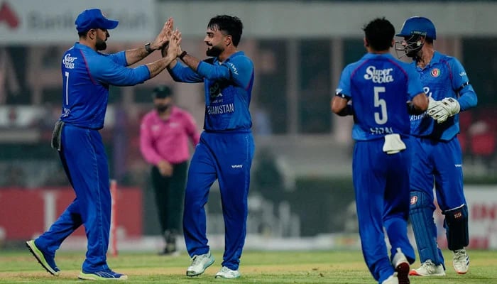 Afghanistans Rashid Khan (second from left) celebrates taking a wicket with teammates during the T20I tri-series match against UAE at the Sharjah Cricket Stadium in Sharjah on September 1, 2025. — Emirates Cricket Board