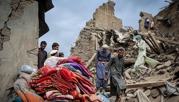 Afghan men walk on the rubble of a damaged house following a deadly magnitude-6 earthquake that struck Afghanistan on Sunday, in Mazar Dara, Kunar province, Afghanistan, September 2, 2025. — Reuters