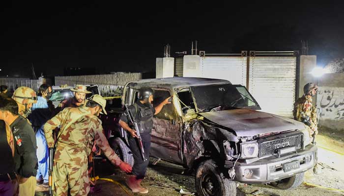 Security personnel inspect a damaged vehicle at the site of an explosion after a suicide bombing in Quetta on September 2, 2025. — AFP