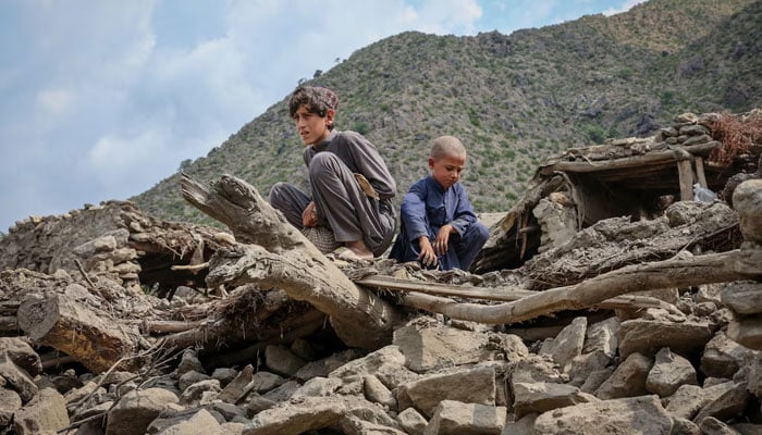 Afghan boys sit on the rubble of a house following a deadly magnitude-6 earthquake that struck Afghanistan on Sunday, at Lulam village, in Nurgal district, Kunar province, Afghanistan, September 3, 2025. — Reuters