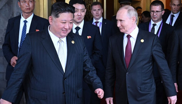 In this pool photograph distributed by the Russian state agency Sputnik, Russian President Vladimir Putin sees North Korean leader Kim Jong Un off following their talks after attending a military parade marking the 80th anniversary of victory over Japan and the end of World War II, in Beijing on September 3, 2025. — AFP