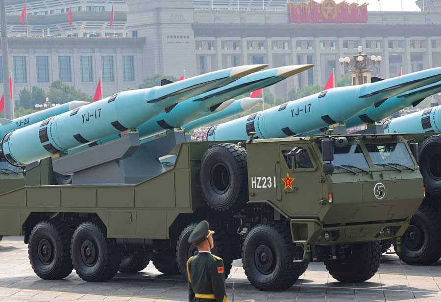 A member of the Peoples Liberation Army stands as YJ-17 hypersonic anti-ship missiles. — Reuters