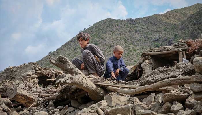 Afghan boys sit on the rubble of a house following a deadly magnitude-6 earthquake that struck Afghanistan on Sunday, at Lulam village, in Nurgal district, Kunar province, Afghanistan. — Reuters