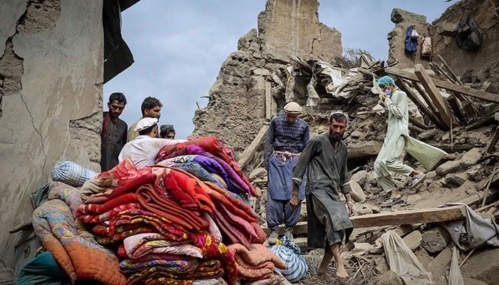 Afghan men walk on the rubble of a damaged house following a deadly magnitude-6 earthquake that struck Afghanistan on Sunday, in Mazar Dara, Kunar province, Afghanistan, September 2, 2025. — Reuters