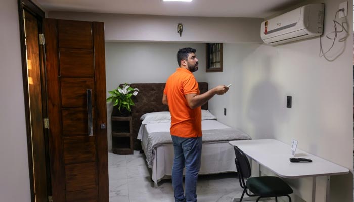 Alcides Moura, manager of the newly renamed COP30 hotel, checks the air conditioning in a room in Belem, Brazil.— AFP