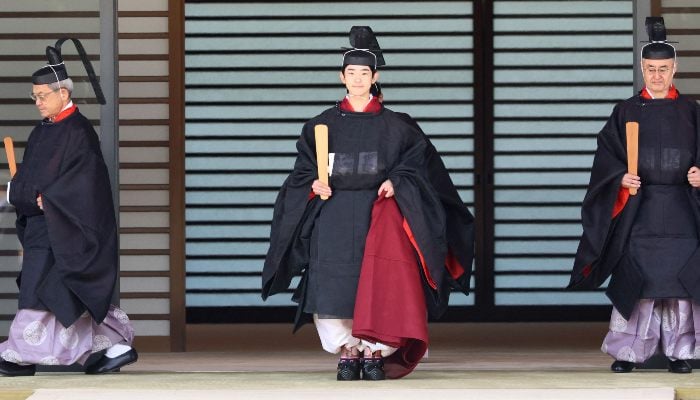 Japanese Prince Hisahito, son of Crown Prince Akishino wearing an ancient ceremonial costume, leaves for a ceremony by a carriage at the Imperial Palace in Tokyo on September 6, 2025. — AFP