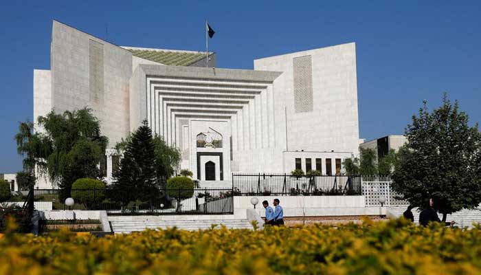 Police officers walk past the Supreme Court of Pakistan building, in Islamabad on April 6, 2022. — Reuters