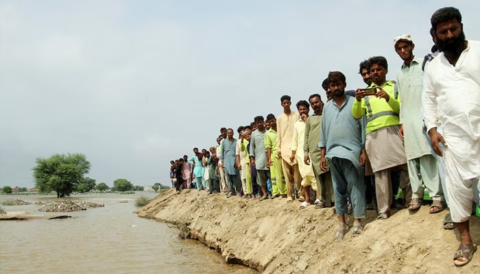 Residents stand at an embankment as they wait to be rescued from a flooded area, following monsoon rains and rising water levels of the Chenab River, in Jalalpur Pirwala, Punjab province, Pakistan, September 8, 2025. — Reuters