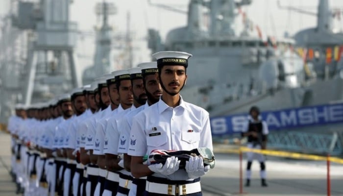 Pakistan Navys servicemen carry national flags of participating countries during the opening ceremony of multinational exercise AMAN-19, in Karachi, on February 8, 2019.— Reuters