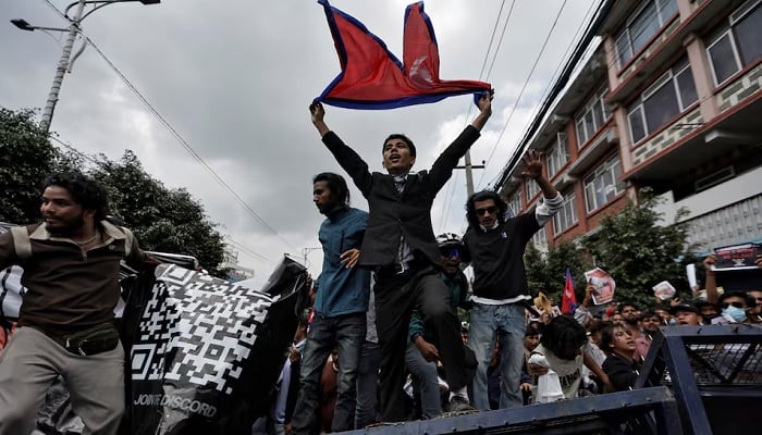 Demonstrators shout slogans as they stand on a barricade during a protest against corruption and the government’s decision to block several social media platforms, in Kathmandu, Nepal, September 8.—Reuters
