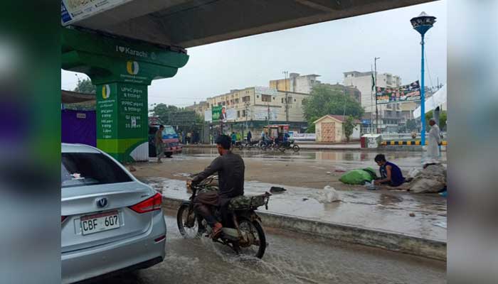Commuters make way through an inundated after rain in Karachi on September 10, 2025. — Geo.tv
