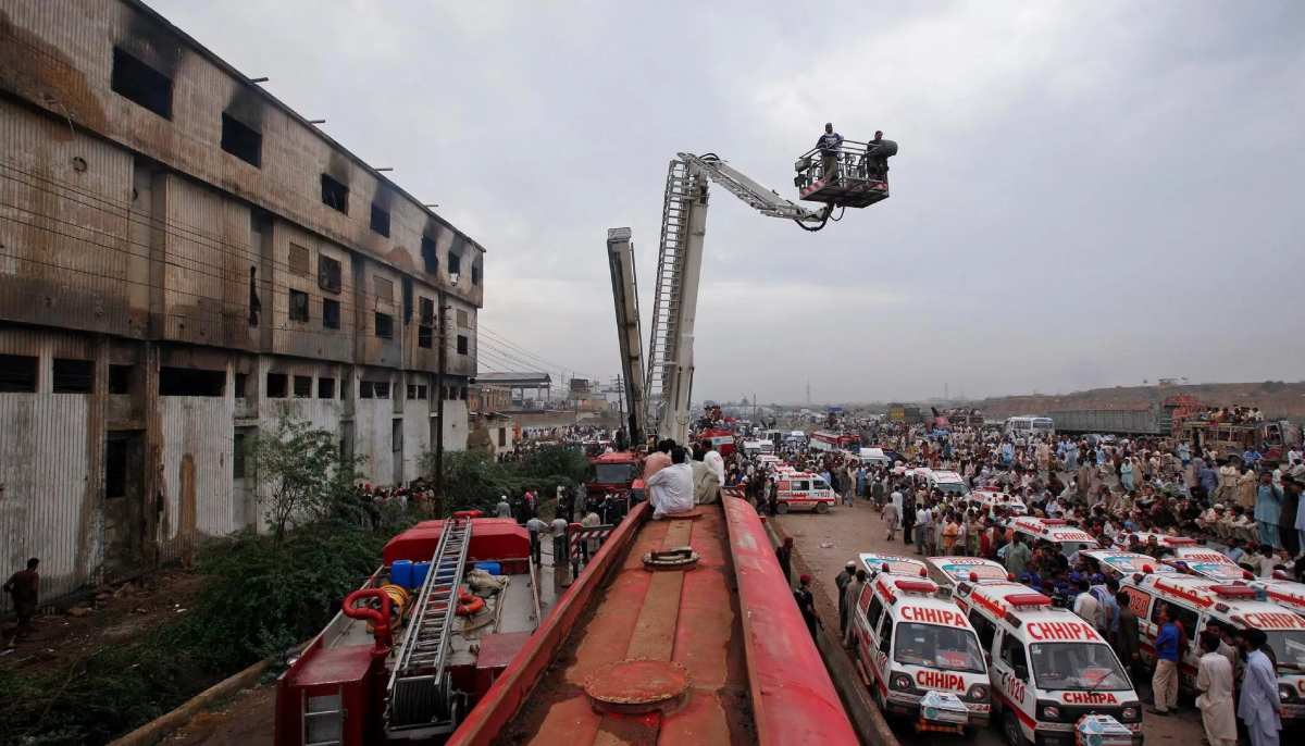 Ambulances and firefighters outside the textile factory in Karachi. — Reuters/File