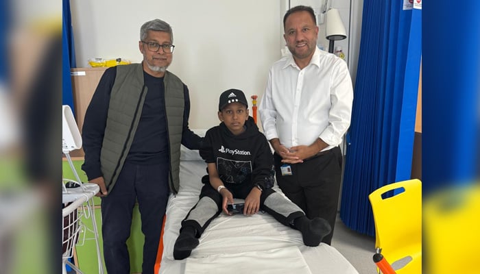 British-Pakistani Dr Sher Bahadur Anjum (right), who is originally from Gilgit Baltistan, stands with a thalasaemia patient after their successful gene therapy treatment. — Reporter
